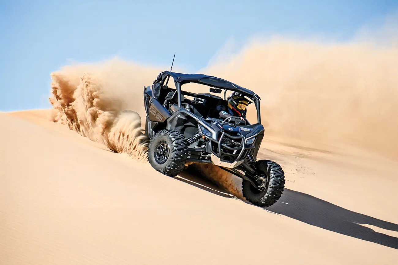 Dune buggy driving over sand dunes